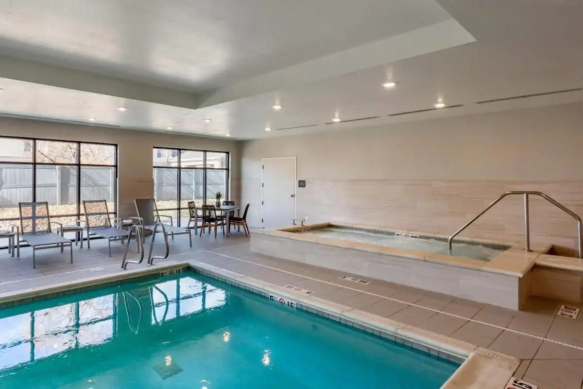 a pool with a hot tub in a building at Comfort Inn & Suites Salt Lake City Airport in Salt Lake City