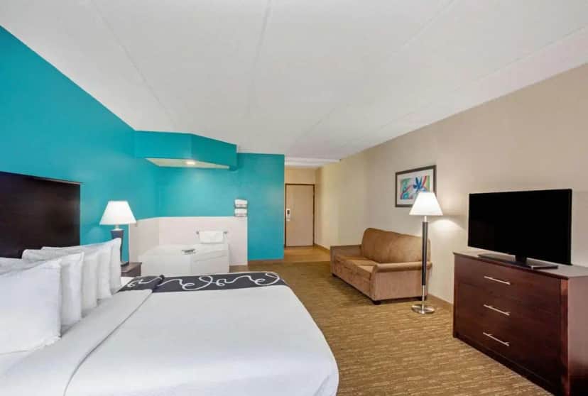 a hotel room with a large bed and a flat screen tv at Comfort Inn & Suites Sarasota I75 in Sarasota