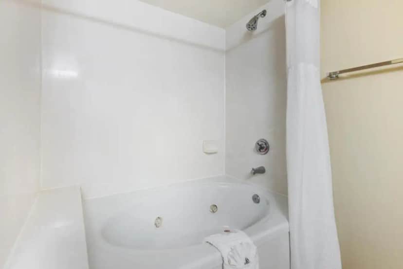a white bathroom with a tub and a shower at Comfort Inn & Suites Tavares North in Tavares