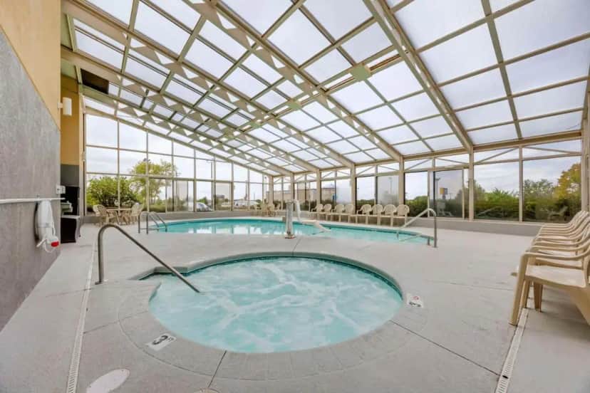 a large swimming pool with a glass ceiling at Comfort Inn South - Springfield in Springfield