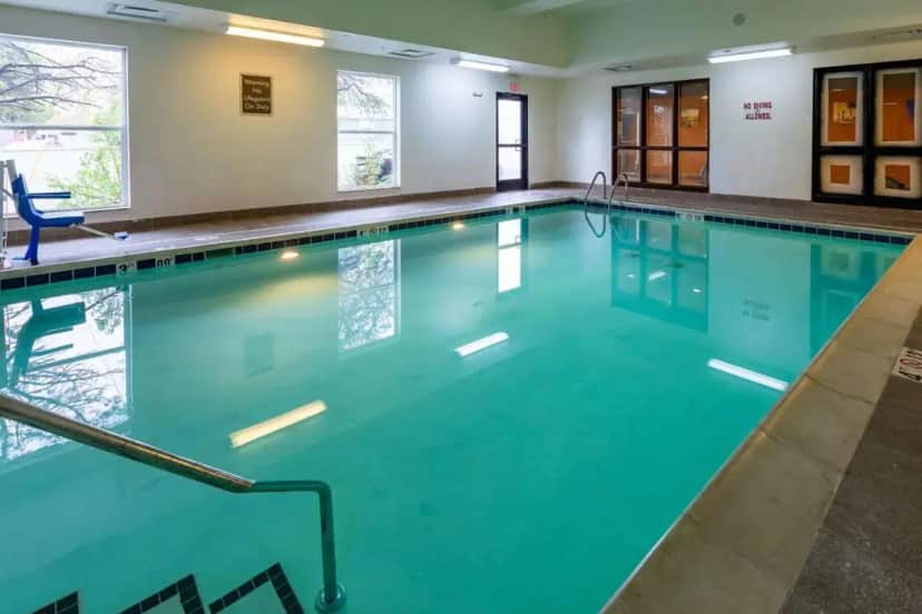 a large swimming pool with blue water at Comfort Suites Denver near Anschutz Medical Campus in Aurora