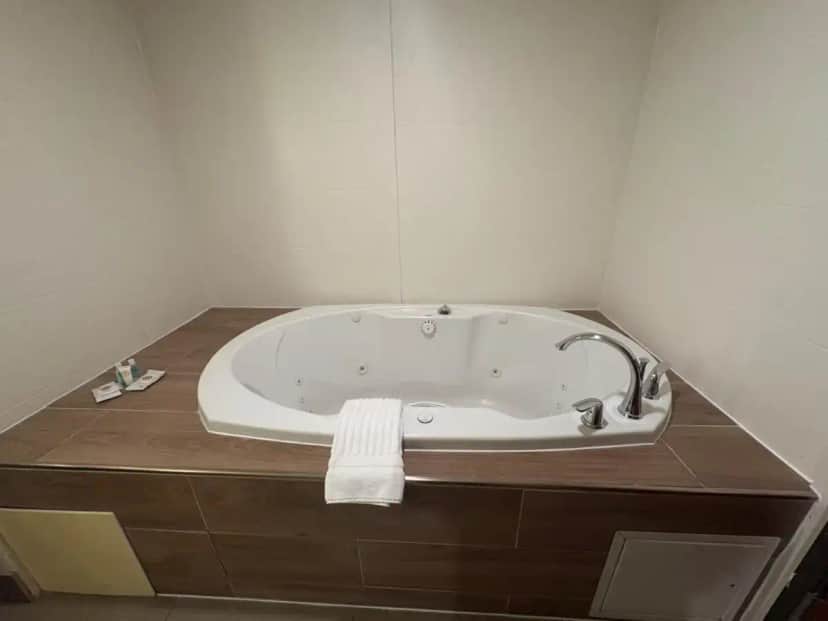 a bathroom with a bath tub in a room at Comfort Suites Near Denver Downtown in Denver