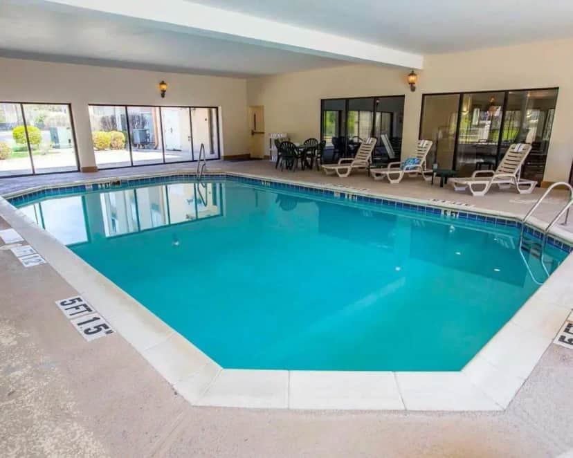 a large pool with blue water in a hotel at Comfort Suites University Area Notre Dame-South Bend in South Bend
