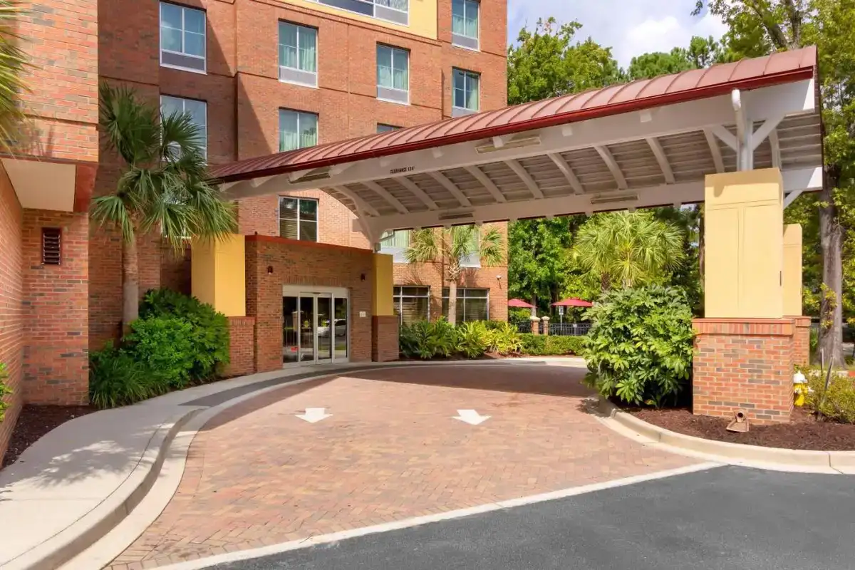 a brick building with a large canopy over a driveway at Comfort Suites Charleston West Ashley in Charleston