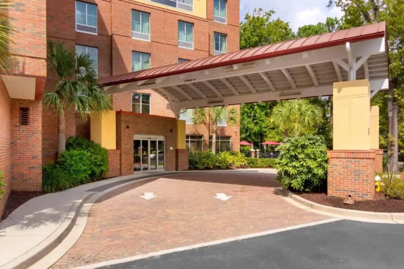a brick building with a large canopy over a driveway at Comfort Suites Charleston West Ashley in Charleston