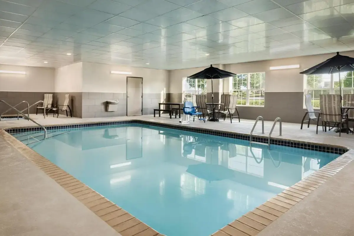 a large pool with blue water in a hotel room at Country Inn & Suites by Radisson, Coralville, IA in Coralville