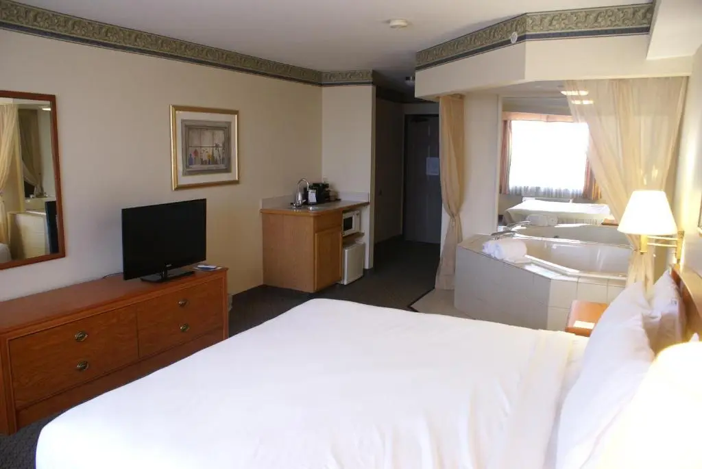 Private in-room jacuzzi tub in the King Suite with Spa Bath at Country Inn & Suites by Radisson, Lansing, MI