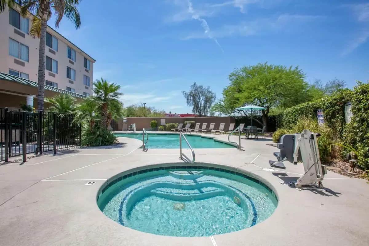 a swimming pool with a hot tub in a courtyard at Country Inn & Suites by Radisson, Mesa, AZ in Mesa
