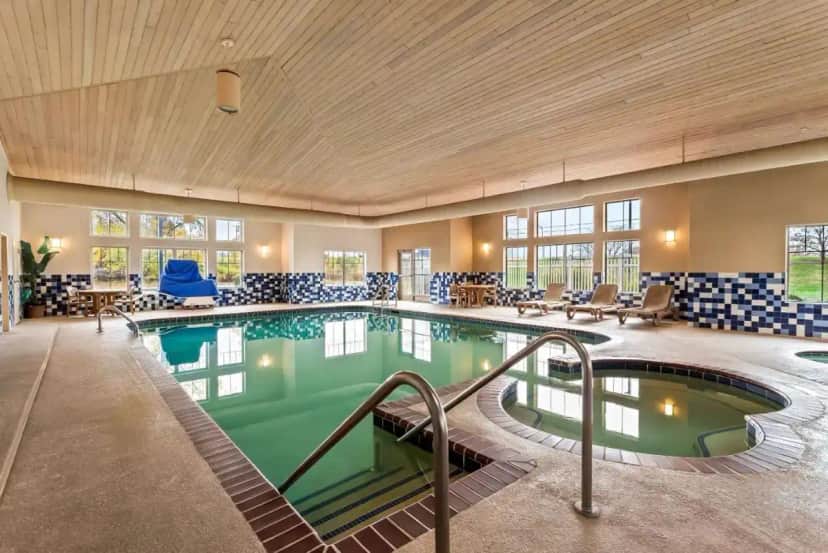 a pool in a hotel room with a swimming pool at Country Inn & Suites by Radisson, Portage, IN in Portage