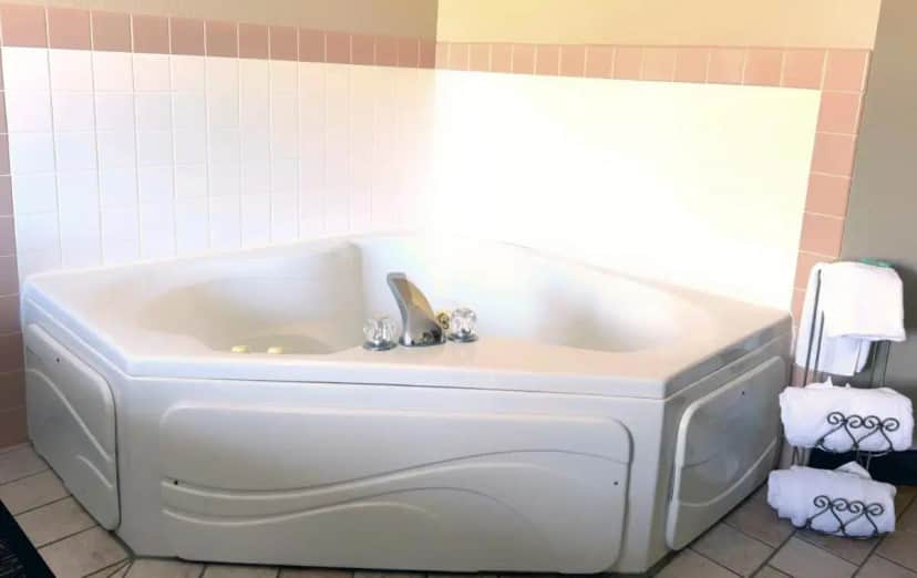 a bath tub with a sink in a bathroom at Country Trails Inn &Suites in Lanesboro