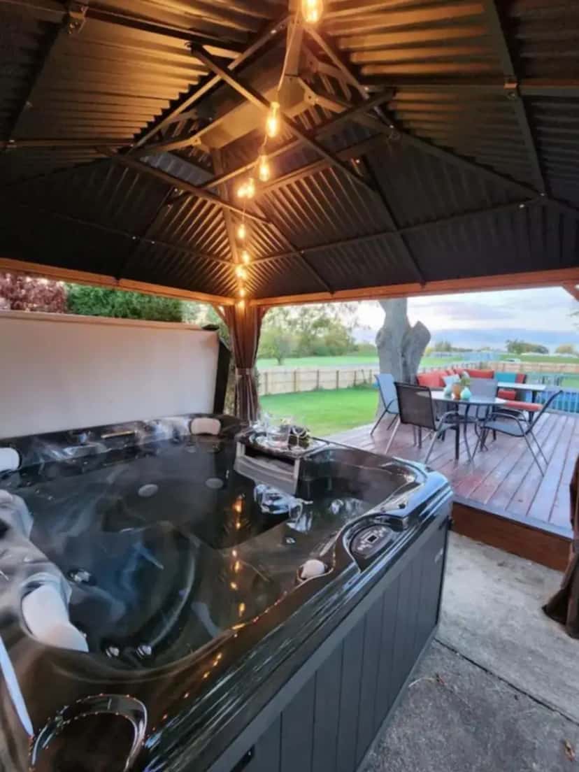 Private outdoor hot tub at Couples Guesthouse, jacuzzi, sauna, pool in Merrillville, IN