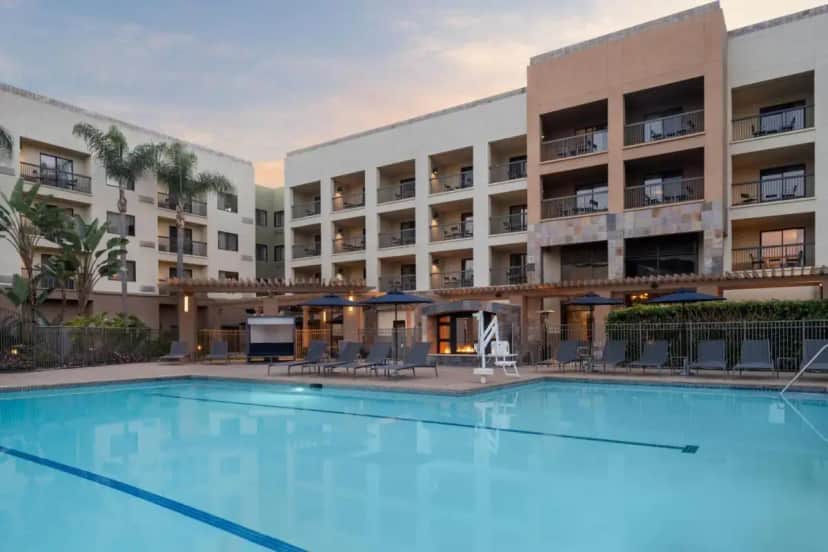 a large swimming pool in front of a hotel at Courtyard by Marriott San Diego Central in San Diego