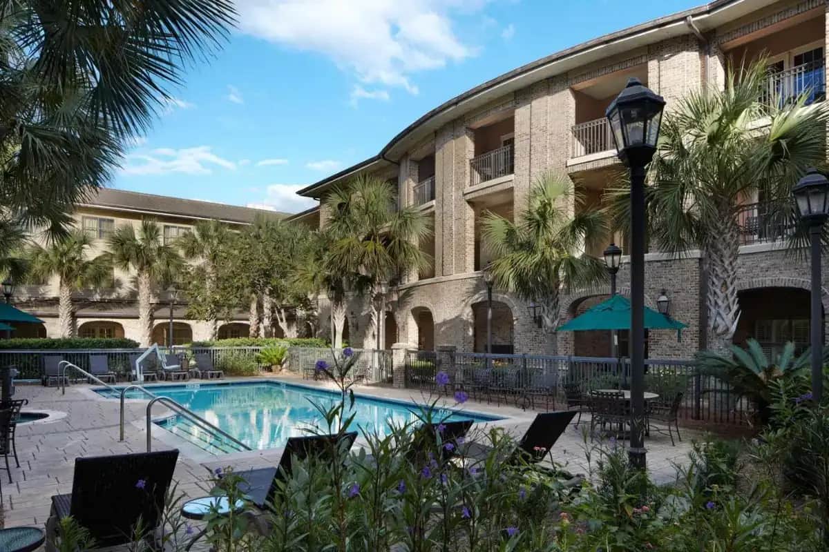 a hotel with a swimming pool in front of a building at Courtyard Charleston Mount Pleasant in Charleston