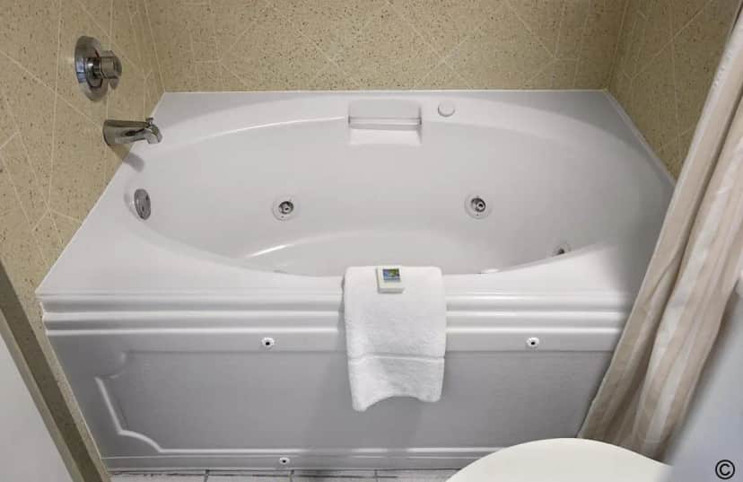 Private in-room jacuzzi tub in the Oceanfront King Suite with Spa Bath at Crown Reef Beach Resort and Waterpark