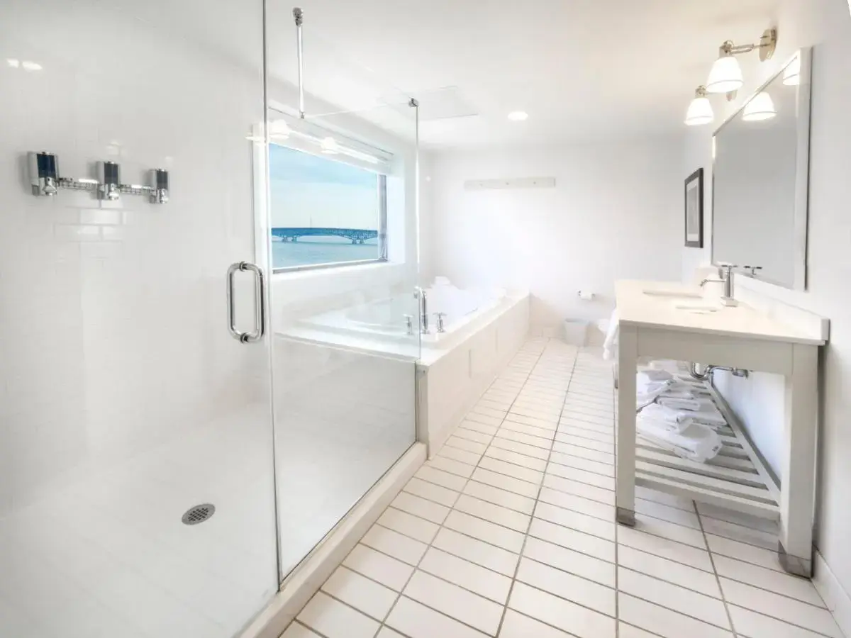 a white bathroom with a shower and a sink at Crowne Plaza Niagara Falls NY - Riverside by IHG in Niagara Falls