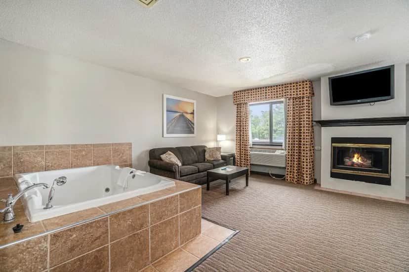 Private in-room jacuzzi in the Suite, 1 King Bed, Jetted Tub (with fireplace and Sofa) at Days Inn & Suites by Wyndham Traverse City