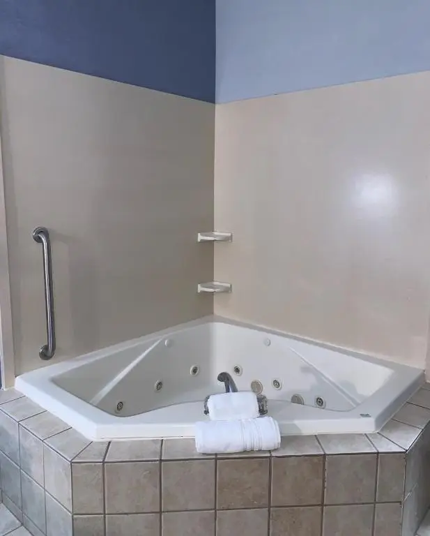 Private in-room jacuzzi tub in the King Suite with Spa Bath at Days Inn by Wyndham Glen Allen