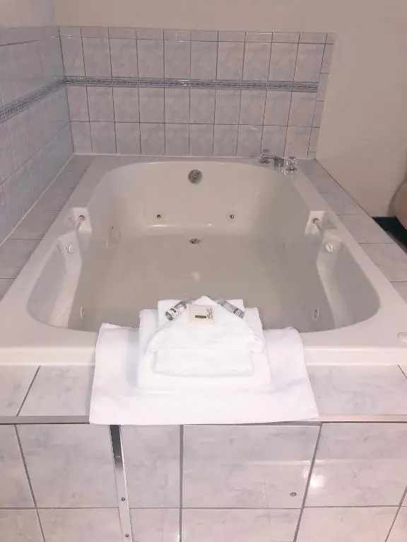 Private in-room jacuzzi tub in the King Suite with Jacuzzi Tub and Sofa Bed at Days Inn by Wyndham Niagara Falls Centre St. By the Falls