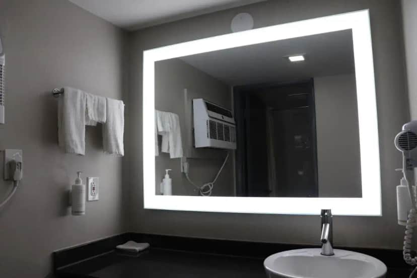 a bathroom with a sink and a large mirror at Days Inn by Wyndham Payson in Payson