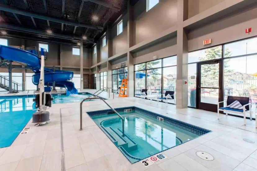 a pool with a slide in a large building at Delta Hotels by Marriott Fargo in Fargo