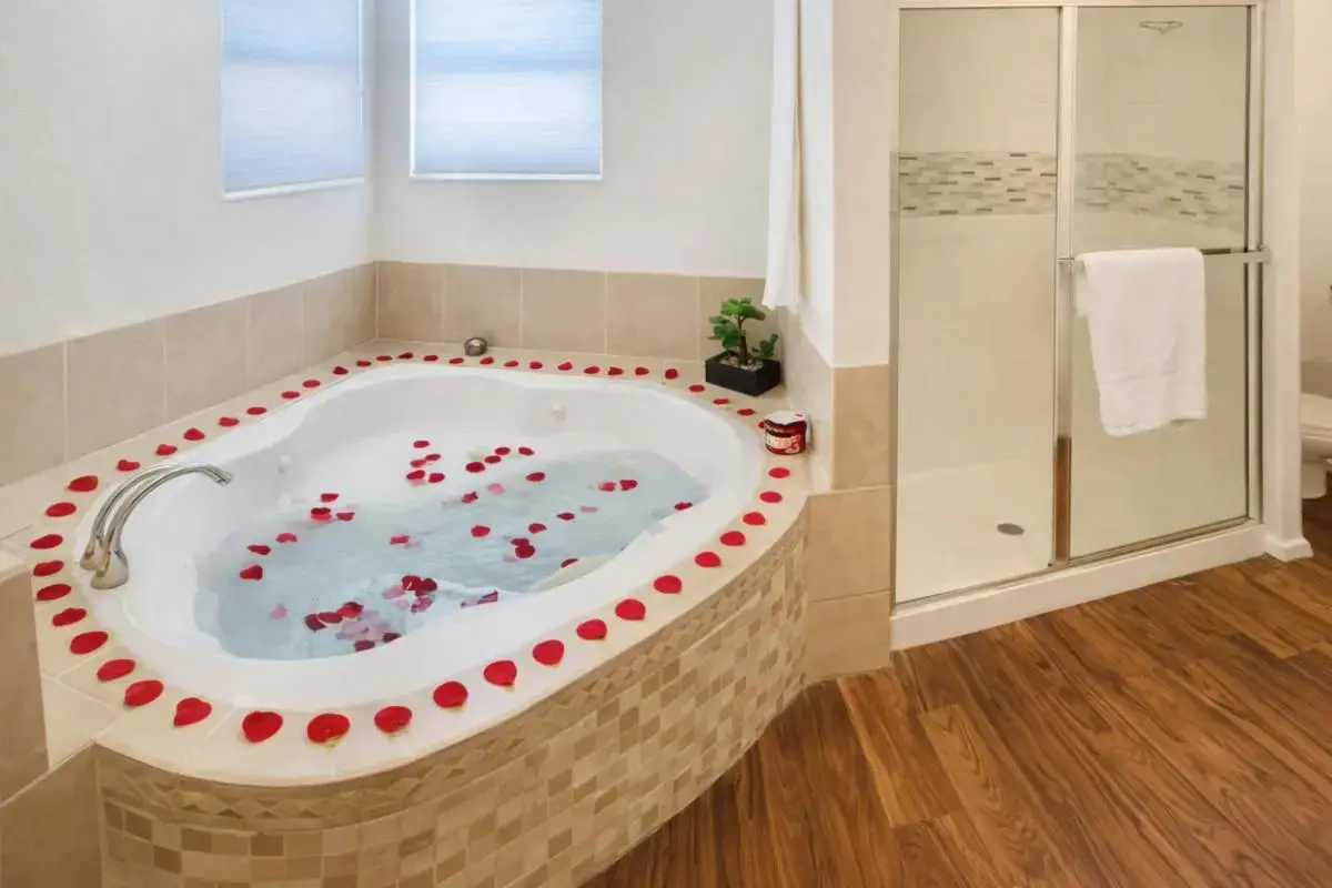 a bathroom with a jacuzzi tub with red accents at Desert Oasis 4 Bedroom Hot Tub Pool Table Pool in Las Vegas