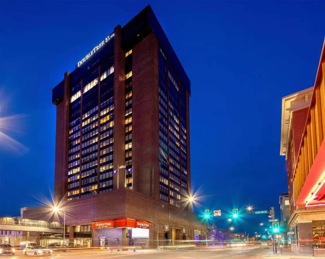 a tall building on a city street at night at Doubletree By Hilton Billings in Billings