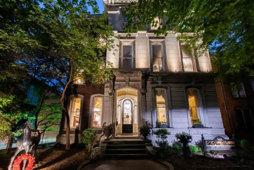 an old house with lights on in front of it at DuPont Mansion Bed & Breakfast in Louisville