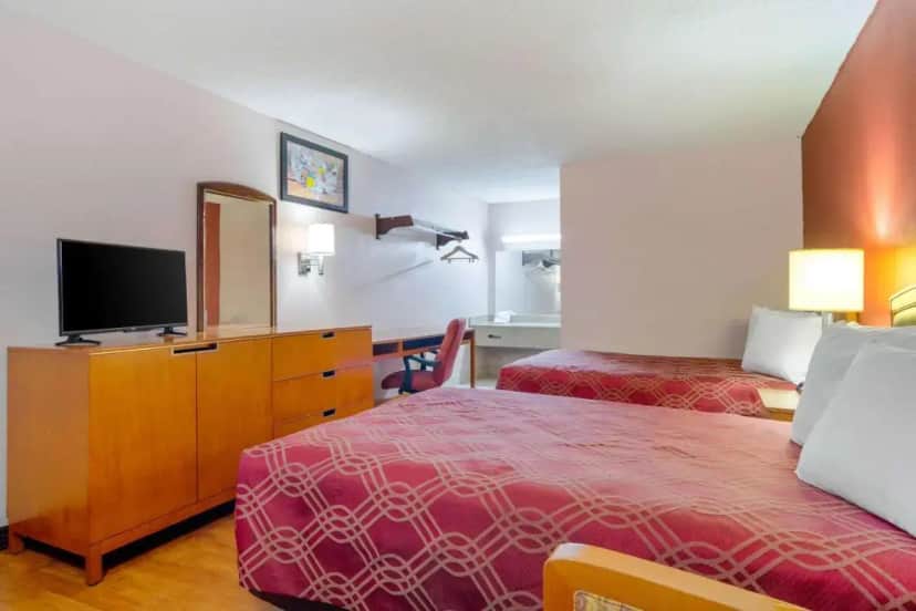 a hotel room with two beds and a flat screen tv at Econo Lodge Decatur - Atlanta East in Decatur