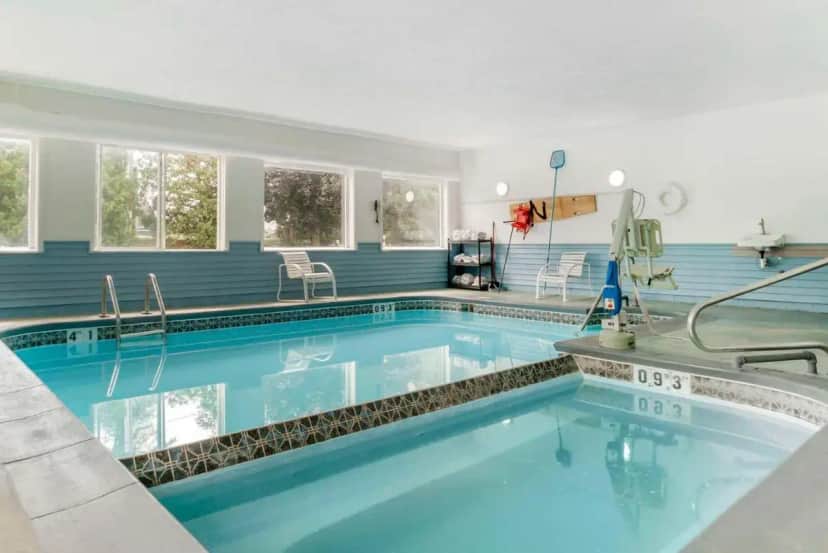 a swimming pool in a house with blue walls at Econo Lodge Traverse City South in Traverse City
