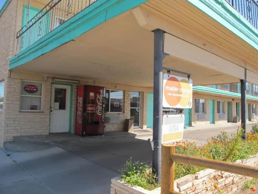 a building with an awning on a street at Economy Inn Ontario in Ontario