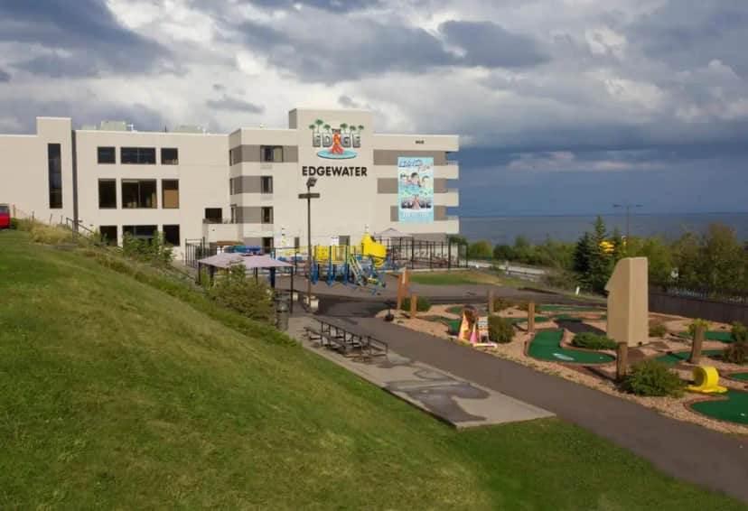 a large building with a playground in front of it at Edgewater Hotel and Waterpark in Duluth