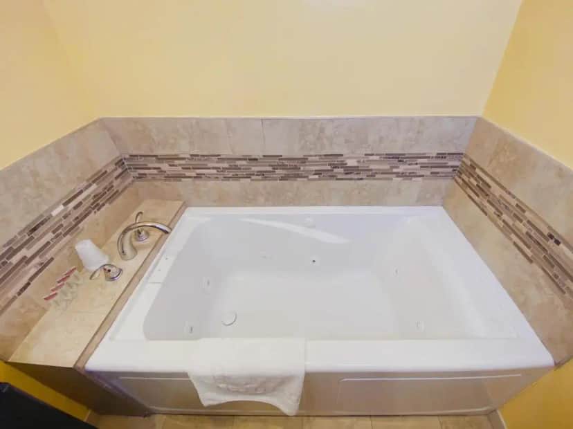 a bathroom with a white tub and a sink at El Patio Inn - Near Universal Studios Hollywood in Los Angeles