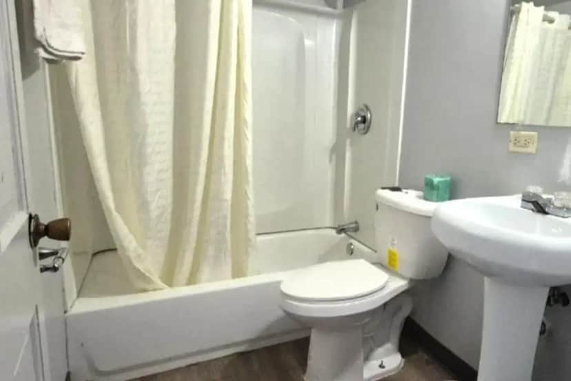 a white bathroom with a toilet and a sink at Elite Inn & Suites South Holland Chicago in South Holland