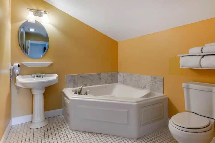 Private in-room jacuzzi tub in the Bedroom Suite with One Queen Bed and Hot Tub at Essex Street Inn & Suites