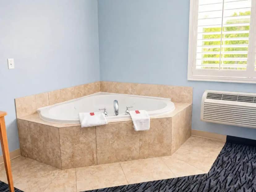 a bathroom with a tub with two towels on it at Executive Inn & Suites Extended Stay - Vernal in Vernal