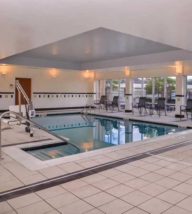 a large swimming pool with chairs and tables at Fairfield Inn and Suites by Marriott Birmingham Pelham/I-65 in Pelham