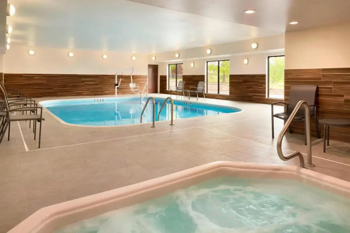 a large indoor pool with a hot tub at Fairfield Inn & Suites Hartford Manchester in Manchester