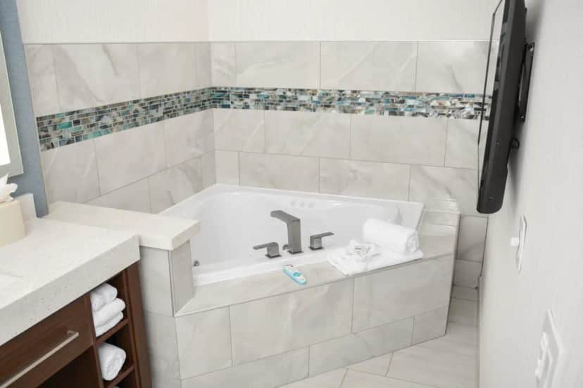 Private in-room jacuzzi tub in the One-Bedroom King Suite with Sofa Bed and Whirlpool at Four Points by Sheraton Fayetteville