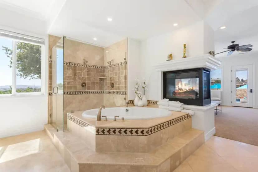 a large bathroom with a tub and a tv at Gaia Inn & Spa- Adult Only- Temecula Wine Country in Temecula