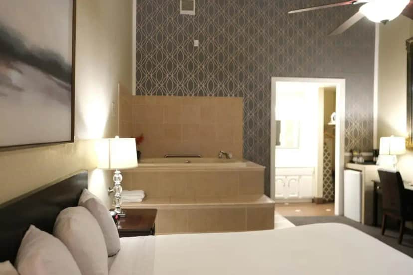 a bedroom with a bed and a bath tub in a room at Golden Haven Hot Springs in Calistoga