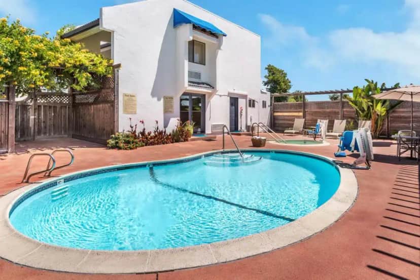 a swimming pool in front of a house at GoodSpring Motel in Napa
