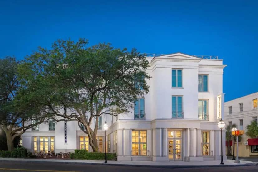 a white building with a tree in front of it at Grand Bohemian Charleston, Autograph Collection in Charleston
