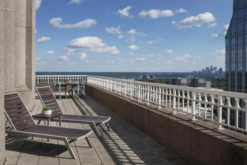 a balcony with chairs and a view of the city at Grand Hyatt Atlanta in Buckhead in Atlanta