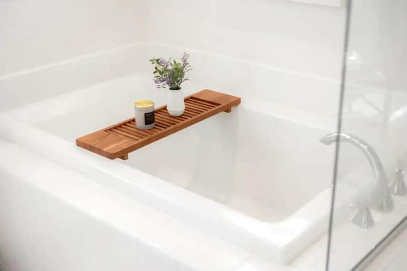 a bathtub with two cups of coffee and flowers on a wooden tray at Grand Luxury 4BD Estate in Irvine in Irvine