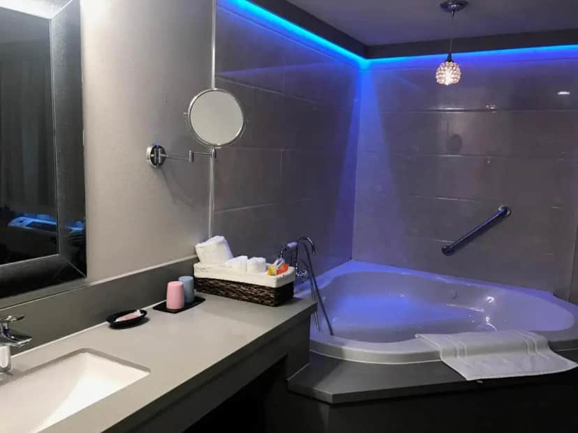 a bathroom with a tub and a sink and a mirror at GreenTree Inn & Suites Los Angeles - Alhambra - Pasadena in Alhambra