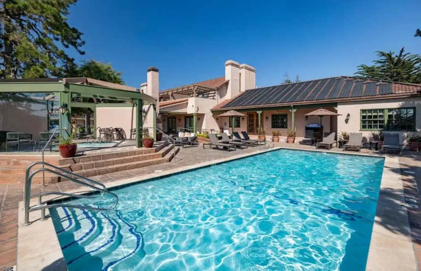 a large swimming pool in front of a house at Half Moon Bay Lodge in Half Moon Bay