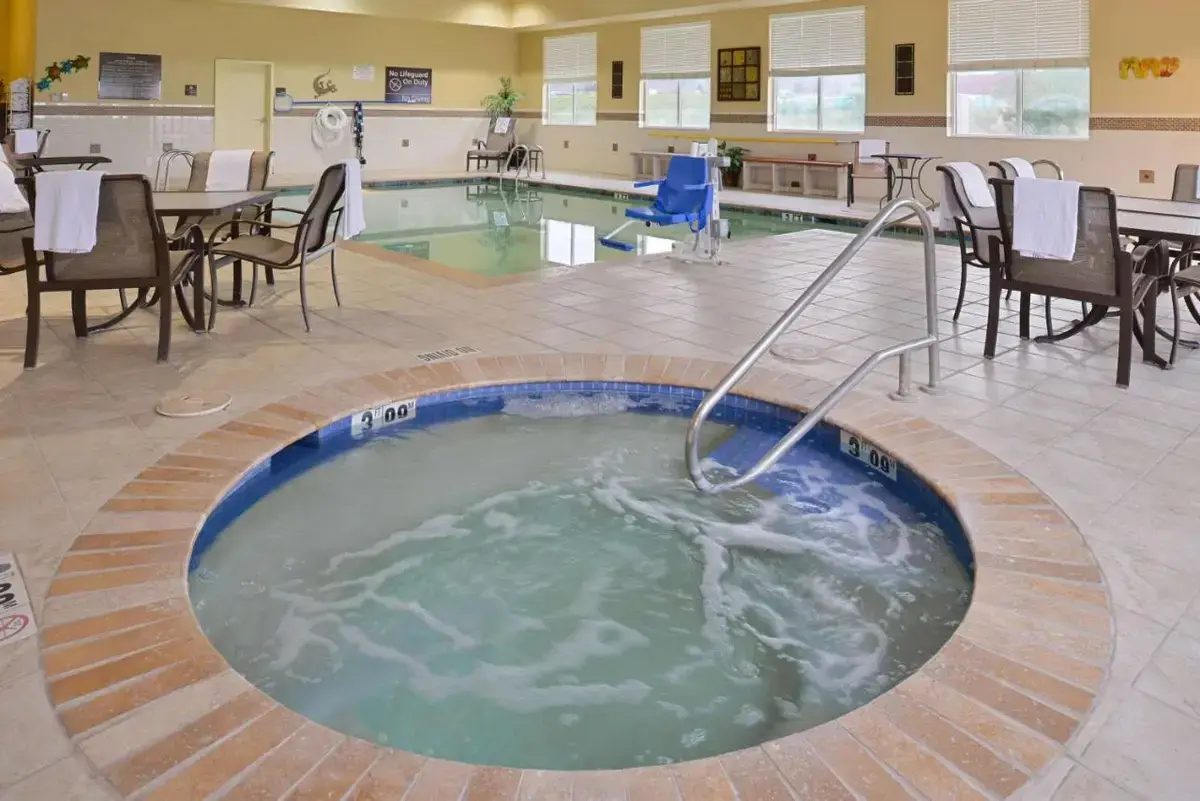a hot tub in the middle of a room with tables and chairs at Hampton Inn Alpine in Alpine