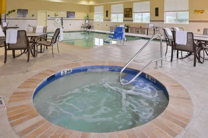 a hot tub in the middle of a room with tables and chairs at Hampton Inn Alpine in Alpine