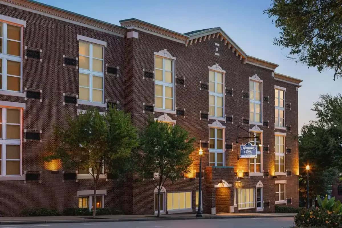 a brick building with trees in front of it at Hampton Inn Columbia-Downtown Historic District in Columbia