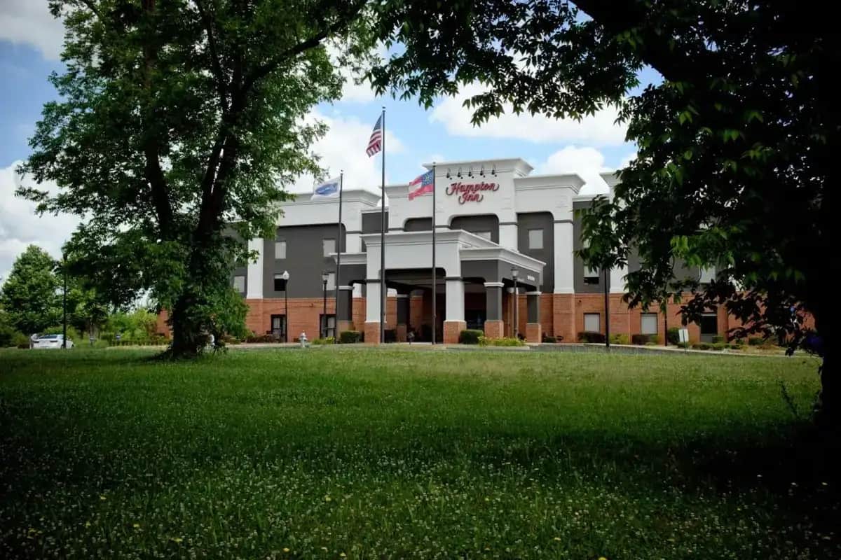 a building with an american flag in front of it at Hampton Inn Fayetteville in Fayetteville